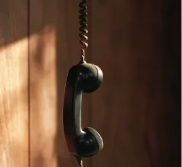 A vintage telephone handset hanging on a wall